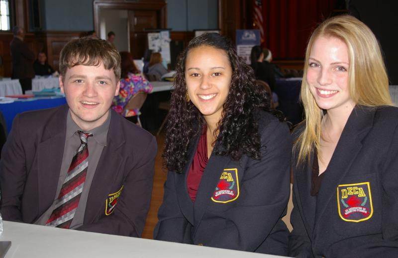 Brian Williams, Amber Ramos, and Lyndsie Pulsifer, Wareham High School seniors and members of DECA (Distributive Economic Clubs of America) were in attendance to tell visitors about their organization. Williams will be competing in sports and email marketing during the international DECA competition in Salt Lake City in April. BY RISHI SIDHU